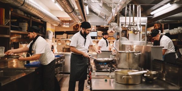 Restaurant kitchen crew preparing food.